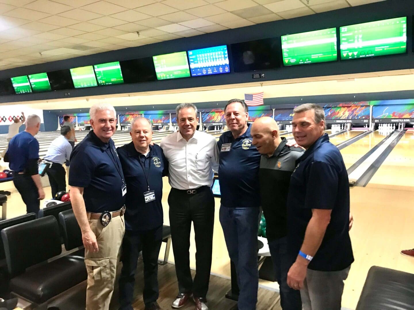 six men are enjoying bowling