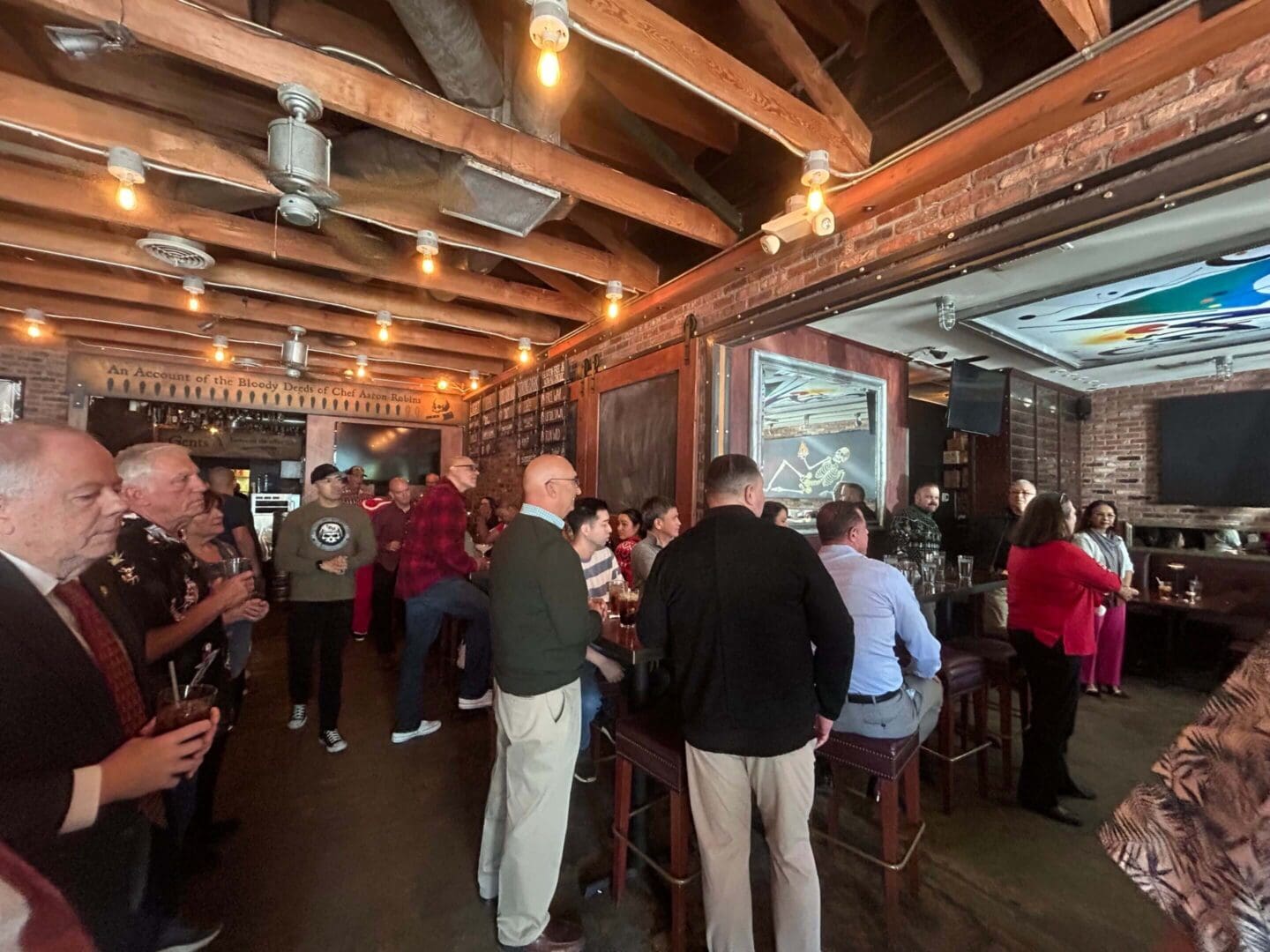 People socializing in a rustic bar setting.
