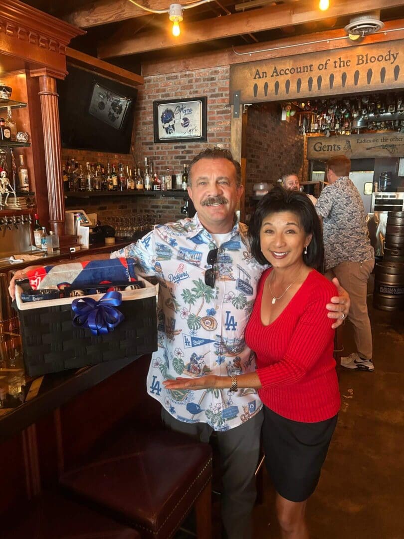 Man and woman smiling in a bar.